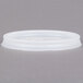 A close up of a white Cambro translucent lid with a straw slot.