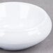 A white melamine butter dish with a small white lid.