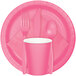 A pink Creative Converting paper plate with a fork and spoon on it.