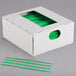 A white box with green plastic strips in it.