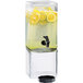 A Cal-Mil glass beverage dispenser with lemons and ice in it.