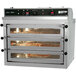 A large Doyon triple deck pizza oven with pizzas in it.