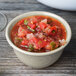 A Santa Fe Ironstone melamine bowl filled with salsa on a wood table.