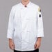 A man wearing a white Chef Revival chef coat with knot cloth buttons.