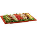 A Tablecraft copper rectangular platter with salad on it.