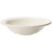 A white bowl with speckled ironstone on a white background.