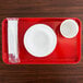 A white bowl and cup on a red Cambro tray.