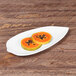 A white Elite Global Solutions Tropicana leaf melamine platter with a plate of fruit on it.