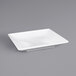 A white square Elite Global Solutions melamine tray on a gray surface.