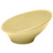 A white Elite Global Solutions slanted melamine bowl with a yellow inside.