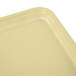 A close up of a Cambro rectangular lemon chiffon tray with a white surface and a yellow surface.