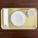 A rectangular Cambro tray with a bowl and cup on it.