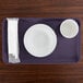 A white bowl and cup on a purple Cambro tray.