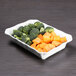A white rectangular melamine dish filled with broccoli and carrots.