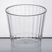 A clear Fineline hard plastic tumbler on a white surface.