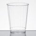 A Fineline clear hard plastic crystal tumbler on a white table.