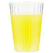 A close-up of a Fineline clear plastic crystal tumbler with yellow liquid inside.
