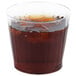 A Fineline clear plastic tumbler filled with brown liquid and ice cubes.