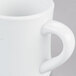A close-up of a CAC Hartford white porcelain mug with a handle.