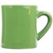 A green mug with a handle.
