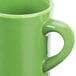 A close up of a CAC green Venice Hartford mug with a handle.