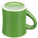 A green mug with a white handle.