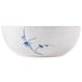 A white bowl with a blue and white design of bamboo on it.