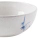 A white bowl with a blue bamboo design.