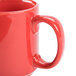 A close up of a red CAC Venice stacking mug with a handle.