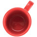 A red mug with a handle.