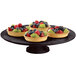 A Tablecraft Midnight Speckle cast aluminum cake stand with fruit tarts on it.