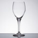 A close-up of a Chef & Sommelier Exalt wine glass on a table with a reflection.