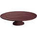 A maroon speckled cast aluminum round cake stand with a white pedestal.