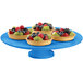 A Tablecraft sky blue cast aluminum round platter with fruit tarts on it.