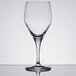 A close-up of a clear Chef & Sommelier wine glass on a reflective surface.