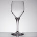 A clear Chef & Sommelier Exalt wine glass on a table.