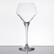 A clear Chef & Sommelier wine glass on a reflective surface.