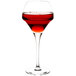A Chef & Sommelier round wine glass filled with red liquid.