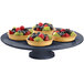 A Tablecraft blue cake stand with fruit on it.