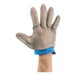 A hand wearing a Victorinox blue chain mesh glove.