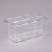 A Cambro clear plastic food pan with a clear lid on a counter.