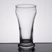 A clear Libbey Pilsner glass on a table.
