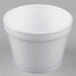 A close-up of a white styrofoam food container with a lid.