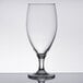 An Arcoroc clear glass wine glass on a table.