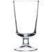 An Arcoroc footed highball glass with a white background.
