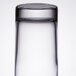 A close-up of a Libbey tall highball glass on a table.