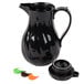 A black plastic coffee carafe with a handle and lid.