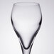 An Arcoroc clear wine glass with a curved bottom.