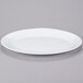 An Arcoroc white oval platter on a gray background.
