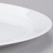 An Arcoroc white oval platter with a rim.